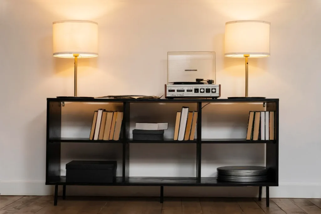 Console Table with Lighting: A console table featuring a table lamp, string lights, and cozy decorative accents.