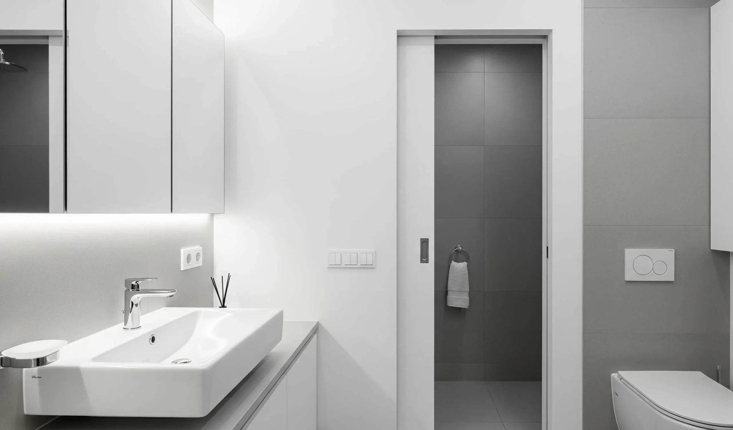 Modern pocket door interior in a minimalist bathroom, sliding seamlessly into a wall cavity.