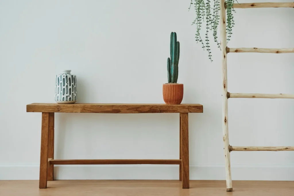 Scandinavian Console Table: A light wood Scandinavian console table with white ceramic decor and minimalist styling.